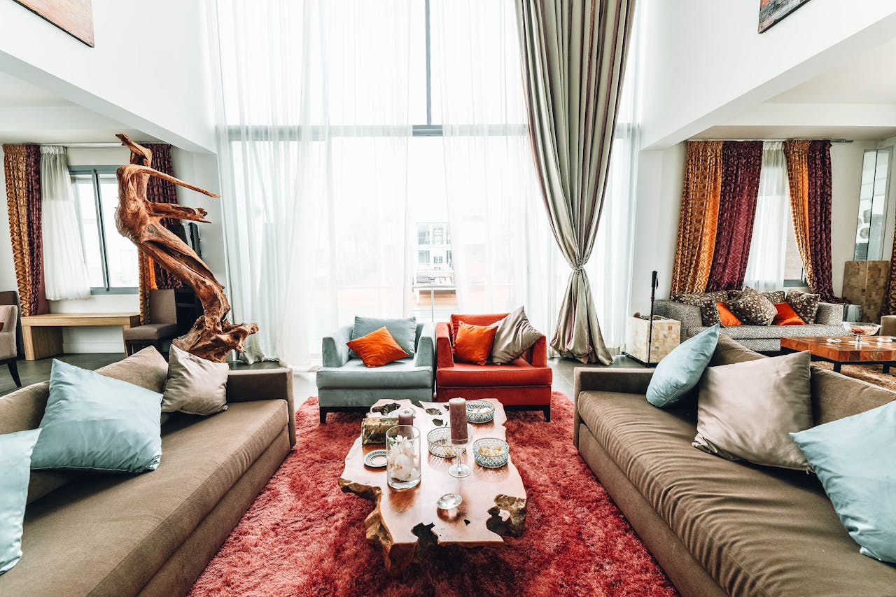 services-02 A spacious, luxurious living room with modern furnishings and natural wood decor.