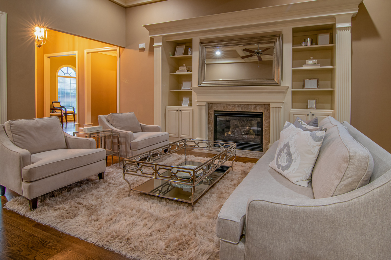 hero-img-02 Luxurious living room featuring modern furniture and a cozy fireplace for a warm ambiance.
